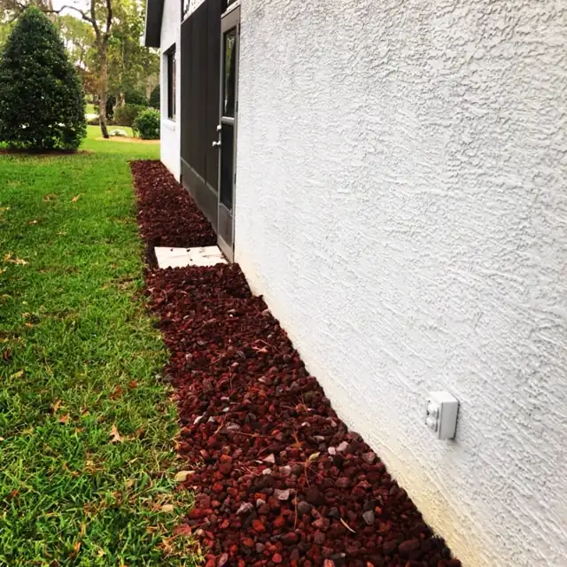 Lava rock bed next to a house in Florida heat